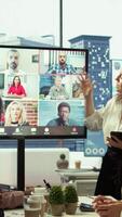 Vertical Briefing meeting between employees and advisory board via videocall network, evaluating monthly reports to increase budget for business development. Work staff discussing with managers. Camera B. video
