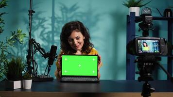 Online show host doing isolated screen laptop unboxing content, filming with professional camera. Tech expert doing chroma key notebook product placement, recording with advanced gear, camera B video