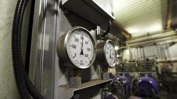 Close up of manometers, pipes and faucet valves of heating system in a boiler room. Stock footage. Modern equipment for heating system. photo