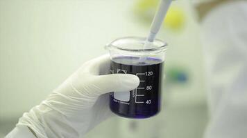 Test tubes closeup. Medical equipment. Close-up footage of a scientist using a micro pipette in a laboratory. Laboratory technician injecting liquid into a microtiter plate. Test tubes. Small depth of photo