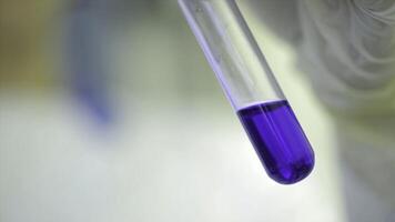 Test tubes closeup. Medical equipment. Close-up footage of a scientist using a micro pipette in a laboratory. Laboratory technician injecting liquid into a microtiter plate. Test tubes. Small depth of photo