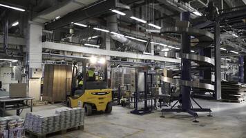Logistic and distribution warehouse. Clip. Empty warehouse full of cargo. Cardboard boxes. Rows of shelves with paper boxes. Commercion concept. Parcels are Moving on Belt Conveyor at Post Sorting photo