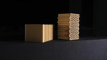 Close-up of two red bricks on black background. Stock footage. Demonstration of two red ceramic blocks with wavy lines for building house on black background photo