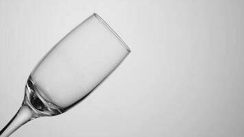 Transparent glass cup on isolated background. Action. Empty transparent glass stands on light isolated background. Empty glass without liquid photo
