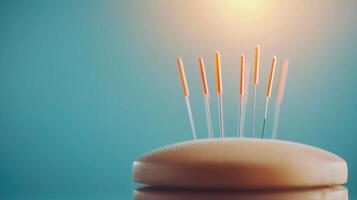 A close-up of an acupuncture treatment showing needles carefully positioned over a soft cushion, set against a soothing blue backdrop for relaxation and healing. photo