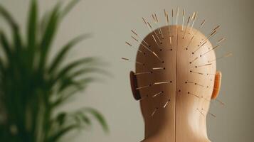 A focused view of a mannequin head with acupuncture needles positioned on the scalp, representing traditional healing methods in a serene, plant-filled environment. photo