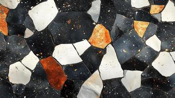 Colorful mosaic texture featuring black, white, and orange fragments arranged artistically. photo