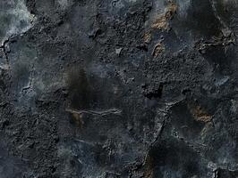 A black and grey wall with a lot of cracks and holes photo