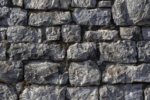 Rock wall with various sized rocks. Natural stone texture background. photo