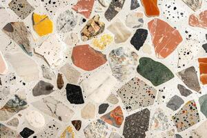 A mosaic tile floor with a variety of colored stones photo