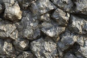 A close up of a rock wall with many rocks of various sizes photo