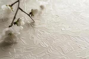 A white floral patterned table cloth with a branch of white flowers on it photo
