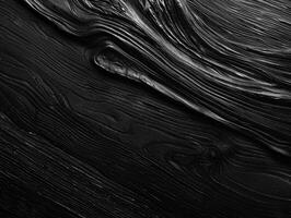 A black wooden surface with a grainy texture photo