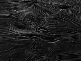 Black wooden surface with a grainy texture. Dark wood background for design projects. photo
