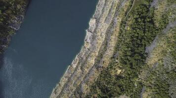 Amazing views over the trees and lakes during the Autumn season. Shot. Top view on Azure shore of a lake with forest landscape. Aerial view of amazing sunset over the nature park photo