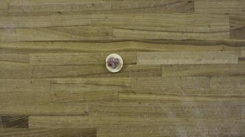 Top view on male hands making dumplings, Man makes dough and meat of dumplings. Cooking at home, hands make meat dumplings on a wooden table. Dumplings, flour, leeks, rolling pin, on wooden table. photo