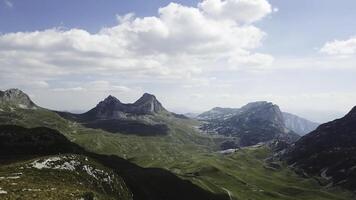 Top view of mountain panorama. Stock. Sunny day with clouds in mountains. Exciting landscape of mountains and cliffs. Mountain valley with rocky cliffs photo