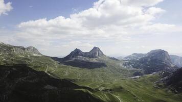 Top view of mountain panorama. Stock. Sunny day with clouds in mountains. Exciting landscape of mountains and cliffs. Mountain valley with rocky cliffs photo