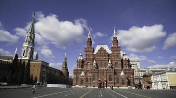 View of square near red square with walking tourists on background of towers. Action. Historical heritage of Russia and famous landmark is Red square photo