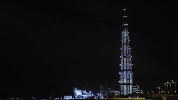 View from the bottom on the beautiful skyscraper Lahta center at night designed by award winning British Architect Tony Kettle. Concept. The Europe's highest tower photo