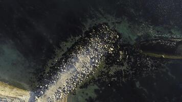Aerial view of the ship washed ashore. Shot. Top view of an abandoned old and rusty shipwreck on a stormy day photo