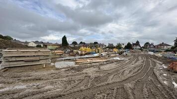 Construction Site with Materials and Muddy Ground photo
