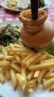 Delicious Burger with Onion Rings and Fries photo