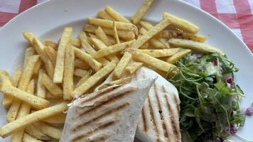 Grilled Sandwich with French Fries and Salad photo
