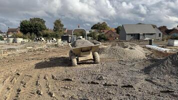 Construction Site with Dumper Truck and Gravel Piles photo