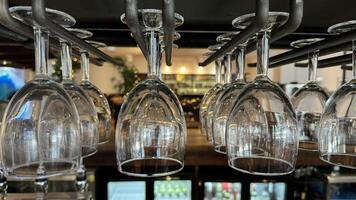 Hanging Wine Glasses in a Bar Setting photo