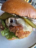 Gourmet Fried Chicken Burger with Pickles and Cheese photo