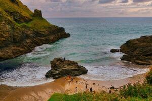 Serene Coastal Beach with Rocky Cliffs in Tintagel, Cornwall, UK photo