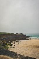 Serene Rocky Beach with Gentle Waves in St Ives, Cornwall, UK photo