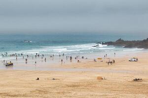 Serene Beach Scene with People Enjoying the Ocean in St Ives, Cornwall, UK photo
