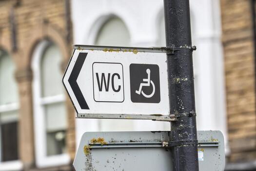 Restroom Direction Sign with Accessibility Symbol photo