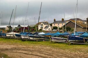 Sailboats on Grassy Shoreline with Cloudy Sky in Penzance, Cornwall, UK photo