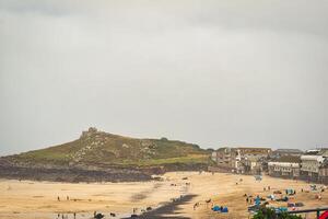 Scenic Beach View with Hill and Overcast Sky in St Ives, Cornwall, UK photo