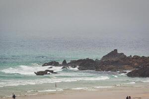 Serene Beach with Rocky Coastline in St Ives, Cornwall, UK photo