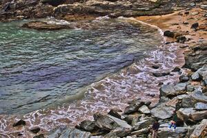 Scenic Rocky Beach with Gentle Waves in Tintagel, Cornwall, UK photo