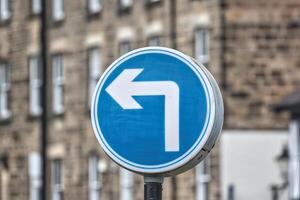 Left Turn Traffic Sign in Urban Setting photo