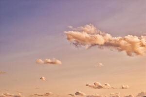 Serene Sunset Sky with Fluffy Clouds photo