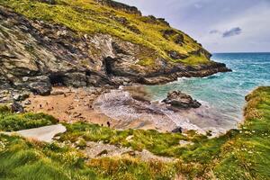 Scenic Beach Surrounded by Rocky Cliffs in Tintagel, Cornwall, UK photo