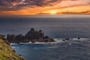 Coastal Sunset Over Rocky Cliffs at Land's End in Cornwall, UK photo