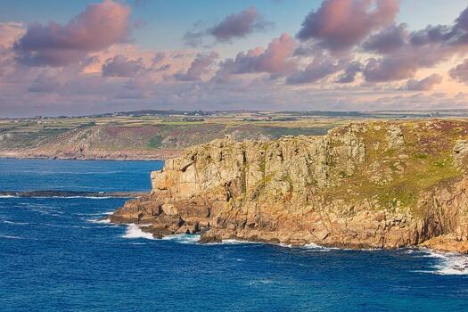 Rugged Coastal Cliffs by the Ocean at Land's End in Cornwall, UK photo