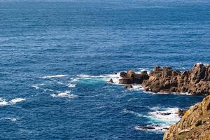 Scenic Ocean View with Rocky Cliffs at Land's End in Cornwall, UK photo