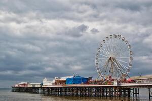 Scenic Pier with Ferris Wheel Under Cloudy Skies in Blackpool, UK photo