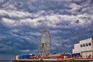 Ferris Wheel on a Pier Under Dramatic Skies in Blackpool, UK photo