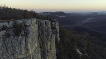 Aerial view of top of the mountains with trees and forest. Shot. Beautiful view of nature at the sunset photo