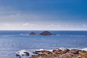 Tranquil Coastal Landscape with Distant Island at Cape Cornwall photo