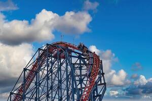 Thrilling Roller Coaster Ride Against Blue Sky in Blackpool, UK photo